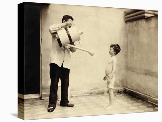 Man Is Sprinkling Boy with Water from Watering Can, 20th Century-Andrew Pitcairn-knowles-Stretched Canvas