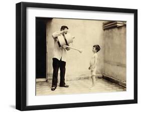 Man Is Sprinkling Boy with Water from Watering Can, 20th Century-Andrew Pitcairn-knowles-Framed Giclee Print