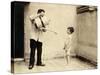 Man Is Sprinkling Boy with Water from Watering Can, 20th Century-Andrew Pitcairn-knowles-Stretched Canvas