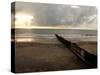 Man Jogs by the Beach Towards the Wall Dividing Mexico and the U.S. in Tijuana, Mexico-null-Stretched Canvas