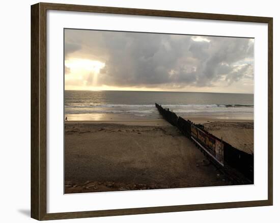 Man Jogs by the Beach Towards the Wall Dividing Mexico and the U.S. in Tijuana, Mexico-null-Framed Photographic Print