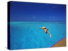 Man Jumping into Tropical Sea from Deck, Maldives, Indian Ocean-Papadopoulos Sakis-Stretched Canvas