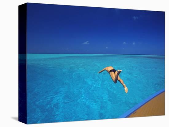 Man Jumping into Tropical Sea from Deck, Maldives, Indian Ocean-Papadopoulos Sakis-Stretched Canvas