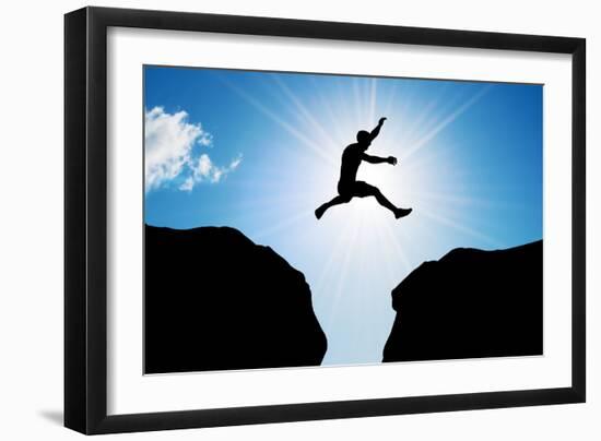 Man Jumping over Precipice between Two Rocky Mountains at Sun Light. Freedom, Risk, Challenge, Succ-Michal Bednarek-Framed Photographic Print