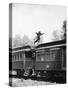 Man Leaping across the Roof of Railroad Cars-null-Stretched Canvas