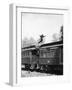 Man Leaping across the Roof of Railroad Cars-null-Framed Photo