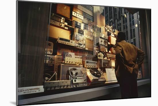 Man Looks at a Window Display of an Electronics Store, New York, New York, 1963-Yale Joel-Mounted Photographic Print