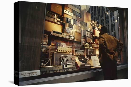 Man Looks at a Window Display of an Electronics Store, New York, New York, 1963-Yale Joel-Stretched Canvas