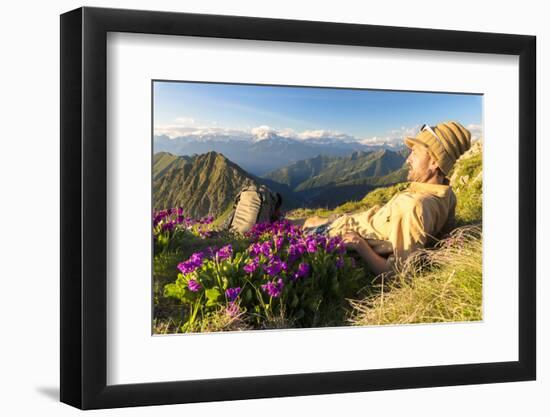 Man lying down on top of Monte Azzarini looks to Monte Disgrazia and Monte Pedena, Albaredo Valley-Roberto Moiola-Framed Photographic Print