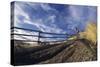 Man Mountain Biking on Countryside Path against Fence and Sky-Nosnibor137-Stretched Canvas