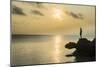 Man on a rock in backlight on the rocky west coast in Ouvea, Loyalty Islands, New Caledonia, Pacifi-Michael Runkel-Mounted Photographic Print