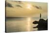 Man on a rock in backlight on the rocky west coast in Ouvea, Loyalty Islands, New Caledonia, Pacifi-Michael Runkel-Stretched Canvas