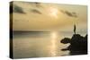 Man on a rock in backlight on the rocky west coast in Ouvea, Loyalty Islands, New Caledonia, Pacifi-Michael Runkel-Stretched Canvas