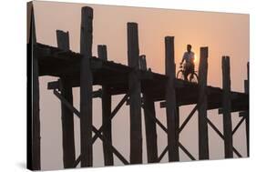 Man on Bicycle Silhouetted at Sunrise Crossing Taungthaman Lake on U Bein Teak Bridge at Dawn-Stephen Studd-Stretched Canvas