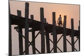 Man on Bicycle Silhouetted at Sunrise Crossing Taungthaman Lake on U Bein Teak Bridge at Dawn-Stephen Studd-Mounted Photographic Print