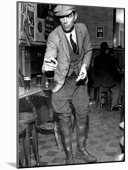 Man Playing Quoits, Like Horse Shoes, in an English Pub-Hans Wild-Mounted Photographic Print