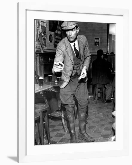 Man Playing Quoits, Like Horse Shoes, in an English Pub-Hans Wild-Framed Photographic Print