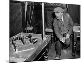 Man Playing Table Skittles in an English Pub-null-Mounted Photographic Print