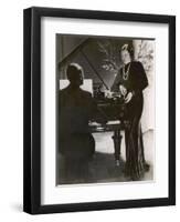 Man Plays a Piano and Looks up at a Glamorous Woman in a Long Dress-null-Framed Photographic Print