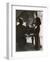 Man Plays a Piano and Looks up at a Glamorous Woman in a Long Dress-null-Framed Photographic Print