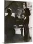 Man Plays a Piano and Looks up at a Glamorous Woman in a Long Dress-null-Mounted Photographic Print