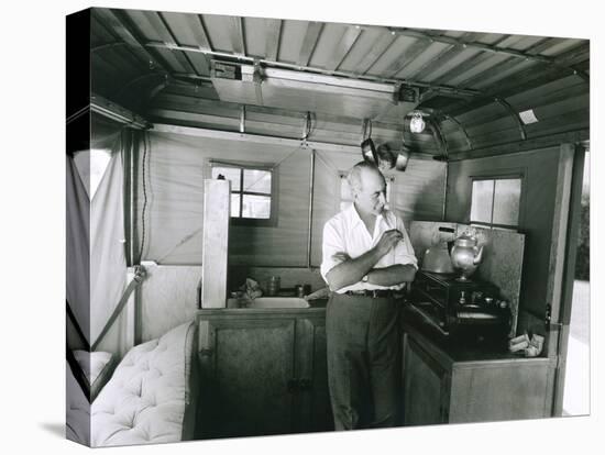 Man Preparing Tea Inside His Camping Trailer-null-Stretched Canvas