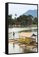 Man Punting Bamboo Raft on Situ Cangkuang Lake at This Village known for its Temple-Rob-Framed Stretched Canvas