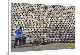 Man pushing cart loaded with wine jars to the big pile in a winery, Zhejiang Province, China-Keren Su-Framed Photographic Print