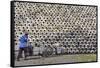 Man pushing cart loaded with wine jars to the big pile in a winery, Zhejiang Province, China-Keren Su-Framed Stretched Canvas