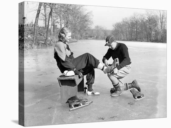 Man Putting on Woman's Ice Skates-Philip Gendreau-Stretched Canvas