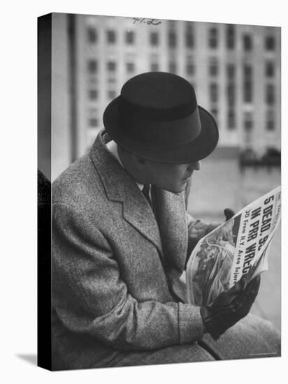 Man Reading a Newspaper While Wearing a Fedora Hat with a Flattened Top and Slim Brim-Ralph Morse-Stretched Canvas