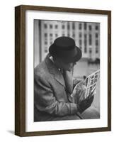 Man Reading a Newspaper While Wearing a Fedora Hat with a Flattened Top and Slim Brim-Ralph Morse-Framed Photographic Print