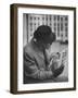 Man Reading a Newspaper While Wearing a Fedora Hat with a Flattened Top and Slim Brim-Ralph Morse-Framed Photographic Print