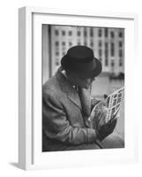 Man Reading a Newspaper While Wearing a Fedora Hat with a Flattened Top and Slim Brim-Ralph Morse-Framed Photographic Print