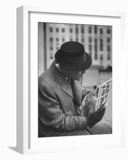 Man Reading a Newspaper While Wearing a Fedora Hat with a Flattened Top and Slim Brim-Ralph Morse-Framed Photographic Print