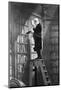 Man Reading on Ladder in Library-null-Mounted Photographic Print
