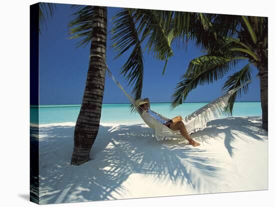Man Relaxing on a Beachside Hammock, Maldives, Indian Ocean-Papadopoulos Sakis-Stretched Canvas