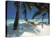 Man Relaxing on a Beachside Hammock, Maldives, Indian Ocean-Papadopoulos Sakis-Stretched Canvas