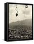 Man Riding Chair Lift Above Town-Jerry Cooke-Framed Stretched Canvas