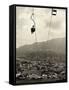 Man Riding Chair Lift Above Town-Jerry Cooke-Framed Stretched Canvas