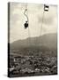 Man Riding Chair Lift Above Town-Jerry Cooke-Stretched Canvas