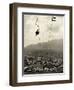 Man Riding Chair Lift Above Town-Jerry Cooke-Framed Photographic Print