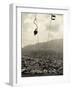 Man Riding Chair Lift Above Town-Jerry Cooke-Framed Photographic Print