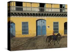 Man Riding Horse Past the Galeria Del Arte (Art Gallery), Plaza Mayor, Trinidad, Cuba-Eitan Simanor-Stretched Canvas