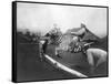 Man Riding Zebra Jumping Fence Photograph - Africa-Lantern Press-Framed Stretched Canvas