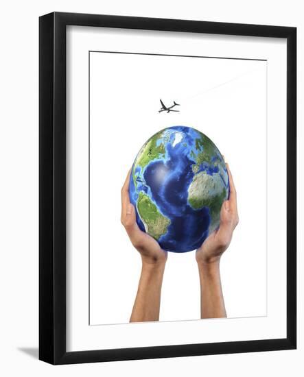Man's Hands Holding the Planet Earth, with a Jet Aircraft Flying Above-null-Framed Art Print
