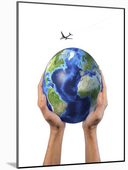 Man's Hands Holding the Planet Earth, with a Jet Aircraft Flying Above-null-Mounted Art Print