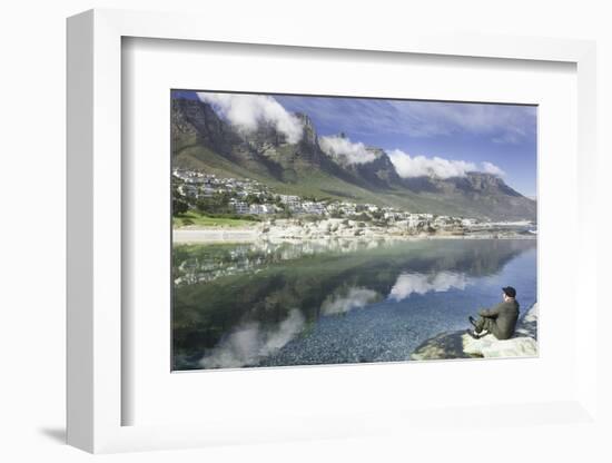 Man Sits on Rock Facing Twelve Apostles Mountain Reflected in Atlantic Ocean, Camp's Bay, Cape Town-Kimberly Walker-Framed Photographic Print