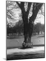 Man Sitting on a Bench and Reading a Newspaper in the Park-Cornell Capa-Mounted Photographic Print