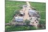 Man Sitting on House Roof in Tiny Agricultural Hamlet Amidst Fields of Vegetables, Rajasthan, India-Annie Owen-Mounted Photographic Print